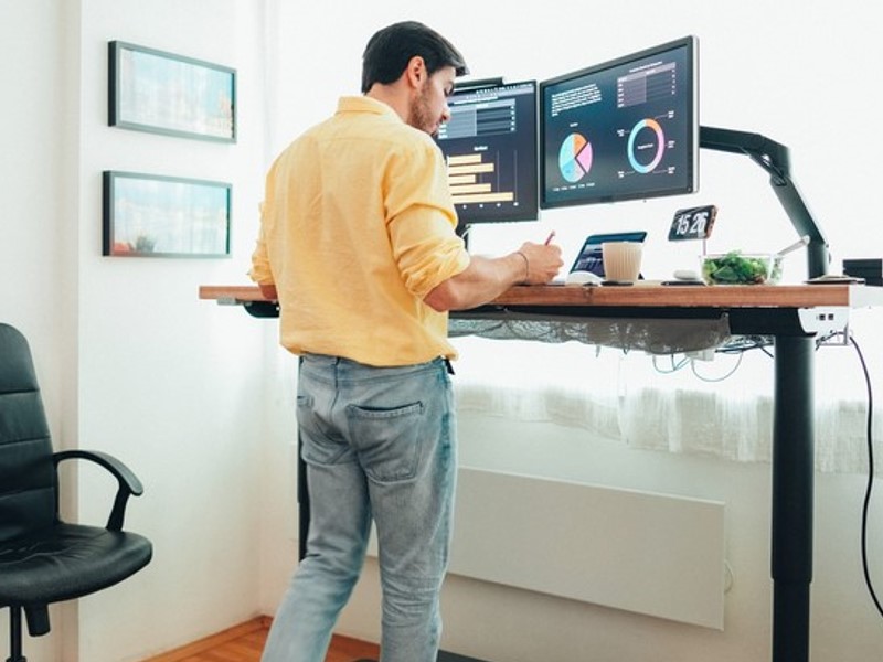 Ergohide height-adjustable desk with various accessories